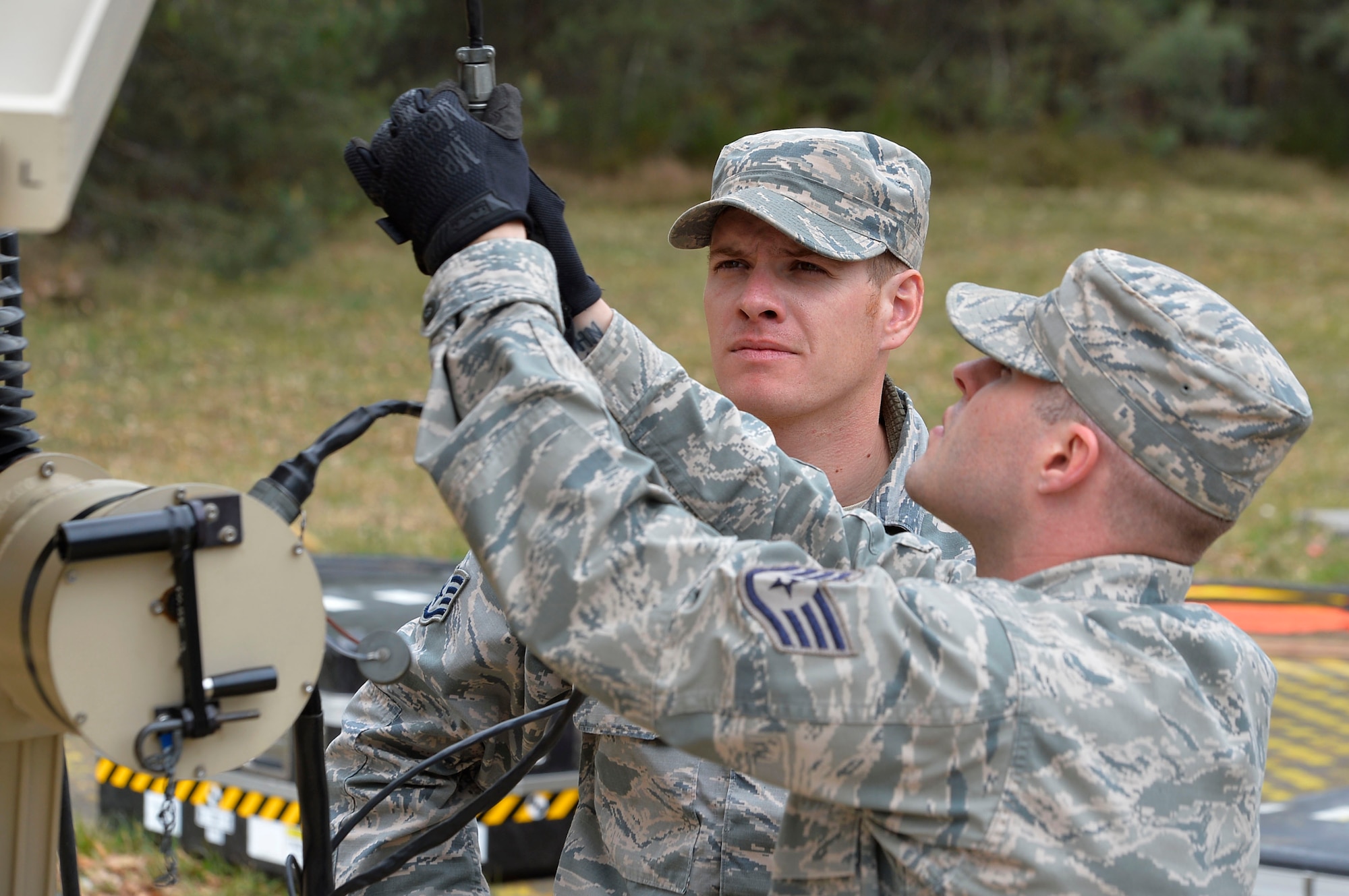 Staff Sgt. Joshua Miles, 1st Combat Communications Squadron radio frequency transmissions technician, and Staff Sgt. Jason Renfroe, 263rd CBCS client systems technician, work on a communications antenna during an exercise on Ramstein Air Base, Germany, April 26, 2017. The exercise featured the first total force integrated combat communications team for U.S. Air Forces in Europe and Air Forces Africa. (U.S. Air Force photo by Airman 1st Class Joshua Magbanua)