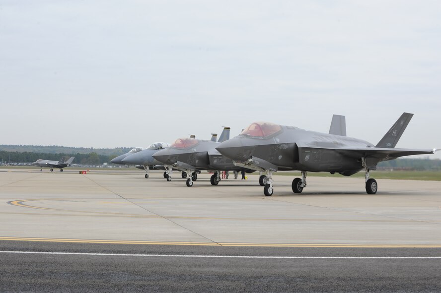 Two F-35As and two F-15Cs wait at the end of the runway at RAF Lakenheath prior to a training sortie. F-35A pilots from the 34th Fighter Squadron and F-15C pilots from the 493rd Fighter Squadron trained together during the first F-35A overseas deployment.  While in Europe, the F-35A will also train with units from the U.S. Air Force, Royal air force and air forces from other NATO allies. (U.S. Air Force photo/Micah Garbarino)