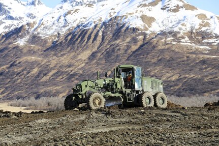 Arizona National Guard Spc. Joseph Charles, a motor vehicle operator with the 259th Engineer Platoon, operates heavy equipment during a runway extension project at Innovative Readiness Training, Old Harbor, Alaska, April 19, 2017. The project will extend the existing Old Harbor runway by 2,700 feet, which will allow larger aircraft to land in Old Harbor. 