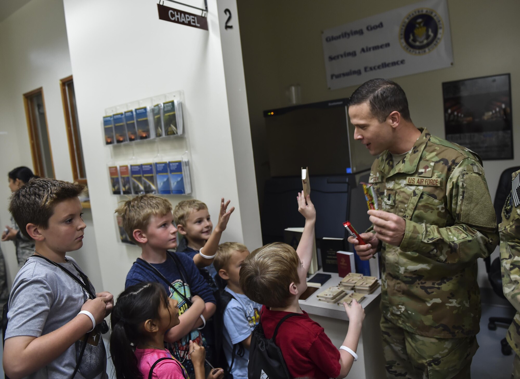 1st Lt. Eric Dixon, a chaplain with the 1st Special Operations Wing, briefs children on chapel services available to deployed service members during Operation Kids Understanding Deployment Operations at Hurlburt Field, Fla., April 22, 2017. Children processed through a deployment line where they received dog tags, shirts and deployment bags. (U.S. Air Force photo by Airman 1st Class Joseph Pick)