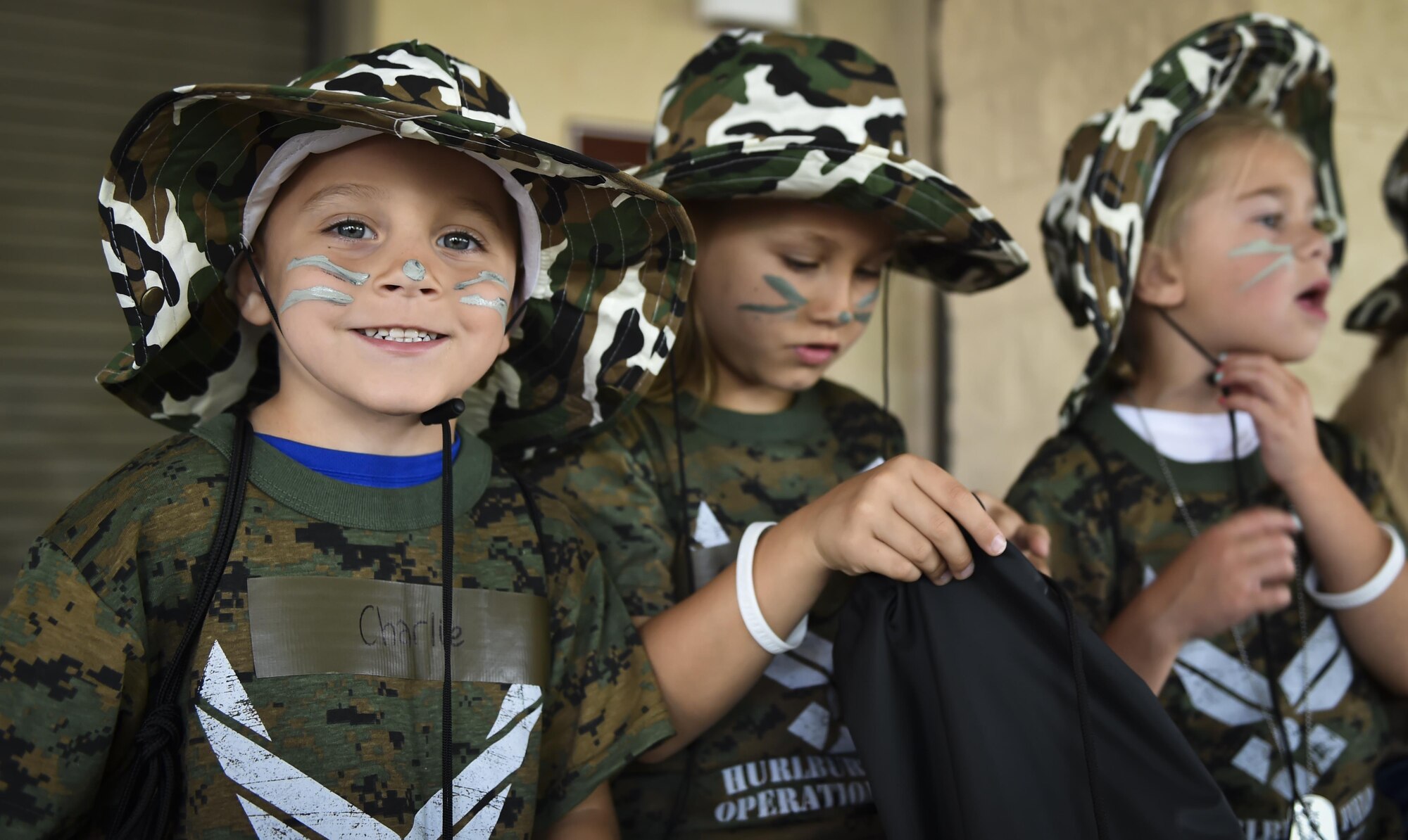 A military child poses for a photo during Operation Kids Understanding Deployment Operations at Hurlburt Field, Fla., April 22, 2017. Operation KUDOS is an educational event aimed to help build resilience in military youth by engaging them in activities that simulate the pre-deployment experience, such as pre-deployment lines and demonstrations. (U.S. Air Force photo by Airman 1st Class Joseph Pick)