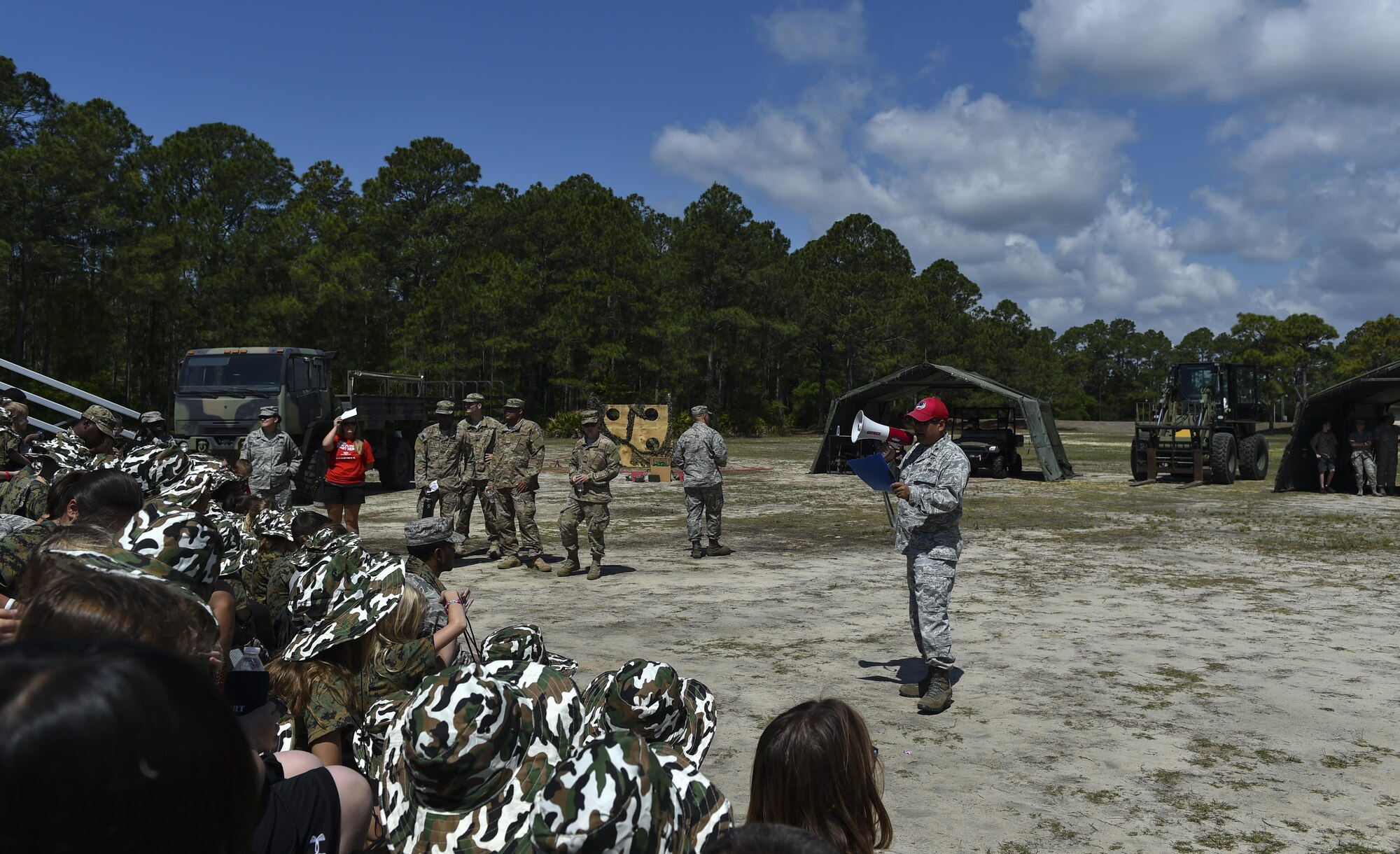 Lt. Col. Jeffrey Lin, the deputy commander of the 823rd RED HORSE Squadron, briefs military children upon arrival to their deployed location during Operation Kids Understanding Deployment Operations at Hurlburt Field, Fla., April 22, 2017. At the deployed location, children visited a medical tent, shopped a field postal exchange and viewed a military working dog demonstration. (U.S. Air Force photo by Airman 1st Class Joseph Pick)