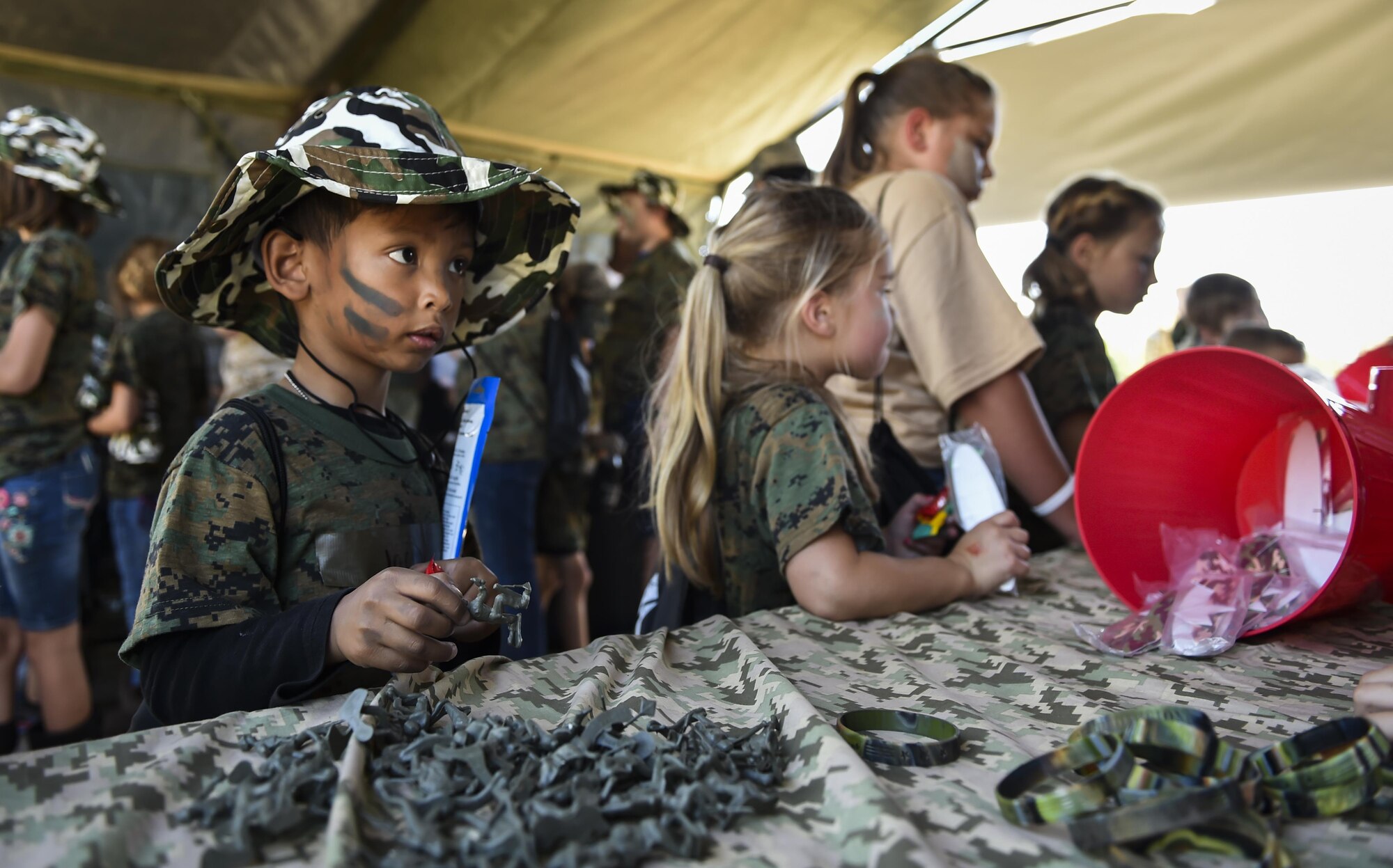 A military child shops at the field postal exchange during Operation Kids Understanding Deployment Operations at Hurlburt Field, Fla., April 22, 2017. Operation KUDOS is an educational event aimed to help build resilience in military youth by engaging them in activities that simulate the pre-deployment experience, such as pre-deployment lines and demonstrations. (U.S. Air Force photo by Airman 1st Class Joseph Pick)