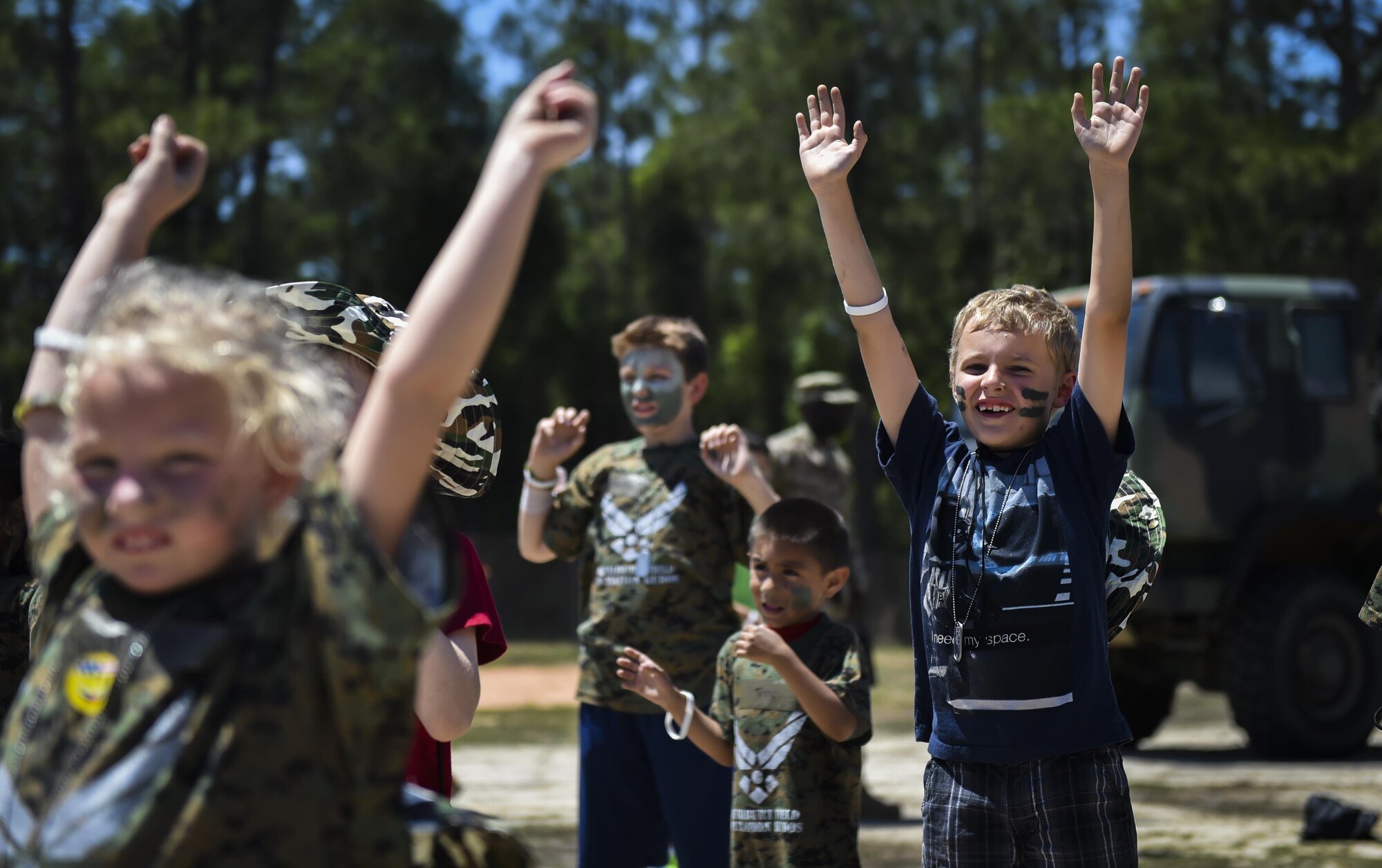 Military children participate in physical training at a deployed location during Operation Kids Understanding Deployment Operations at Hurlburt Field, Fla., April 22, 2017. At the deployed location, children visited a medical tent, shopped a field postal exchange and viewed a military working dog demonstration. (U.S. Air Force photo by Airman 1st Class Joseph Pick)
