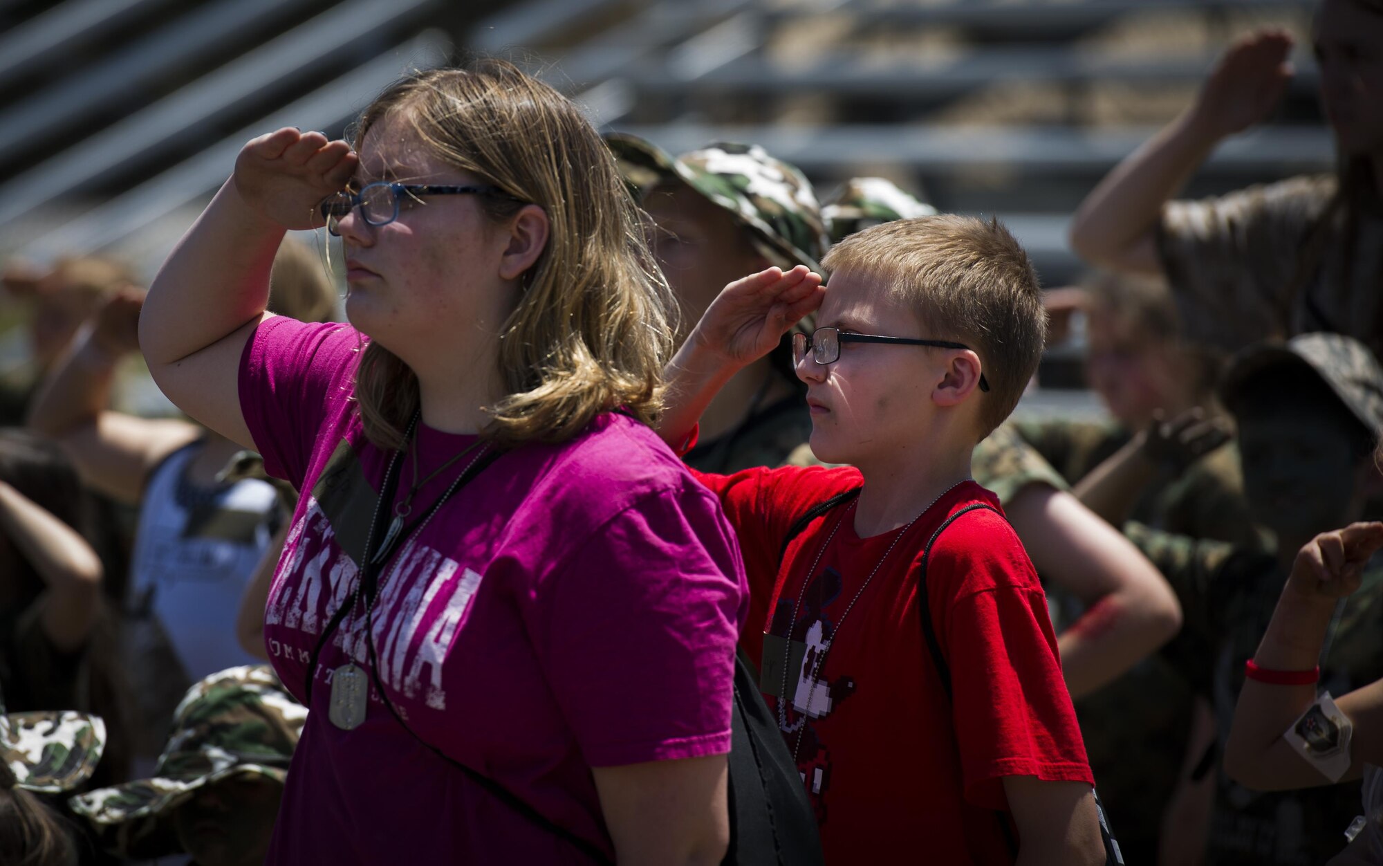 Military children render salutes through the playing of retreat during Operation Kids Understanding Deployment Operations at Hurlburt Field, Fla., April 22, 2017. Operation KUDOS concluded with a homecoming where parents welcomed back their children. (U.S. Air Force photo by Airman 1st Class Joseph Pick)