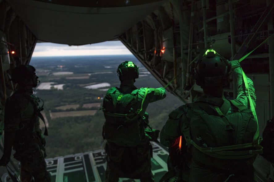 Pararescuemen from the 38th Rescue Squadron prepare to jump from an HC-130J Combat King II, April 24, 2017, at Moody Air Force Base, Ga. All PJs are qualified to conduct both static-line and High altitude, low opening jumps. During a static-line jump, the jumper is attached to the aircraft via the ‘static-line’, which automatically deploys the jumpers’ parachute after they’ve exited the aircraft. (U.S. Air Force photo by Staff Sgt. Ryan Callaghan)