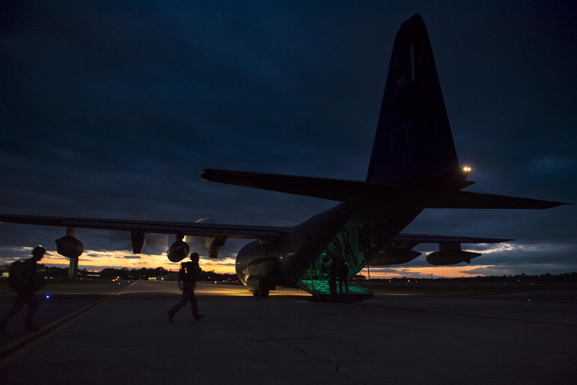 Pararescuemen from the 38th Rescue Squadron, run towards the rear of an HC-130J Combat King II during static-line jumps, April 24, 2017, at Moody Air Force Base, Ga. All PJs are qualified to conduct both static-line and High altitude, low opening jumps. During a static-line jump, the jumper is attached to the aircraft via the ‘static-line’, which automatically deploys the jumpers’ parachute after they’ve exited the aircraft. (U.S. Air Force photo by Staff Sgt. Ryan Callaghan)
