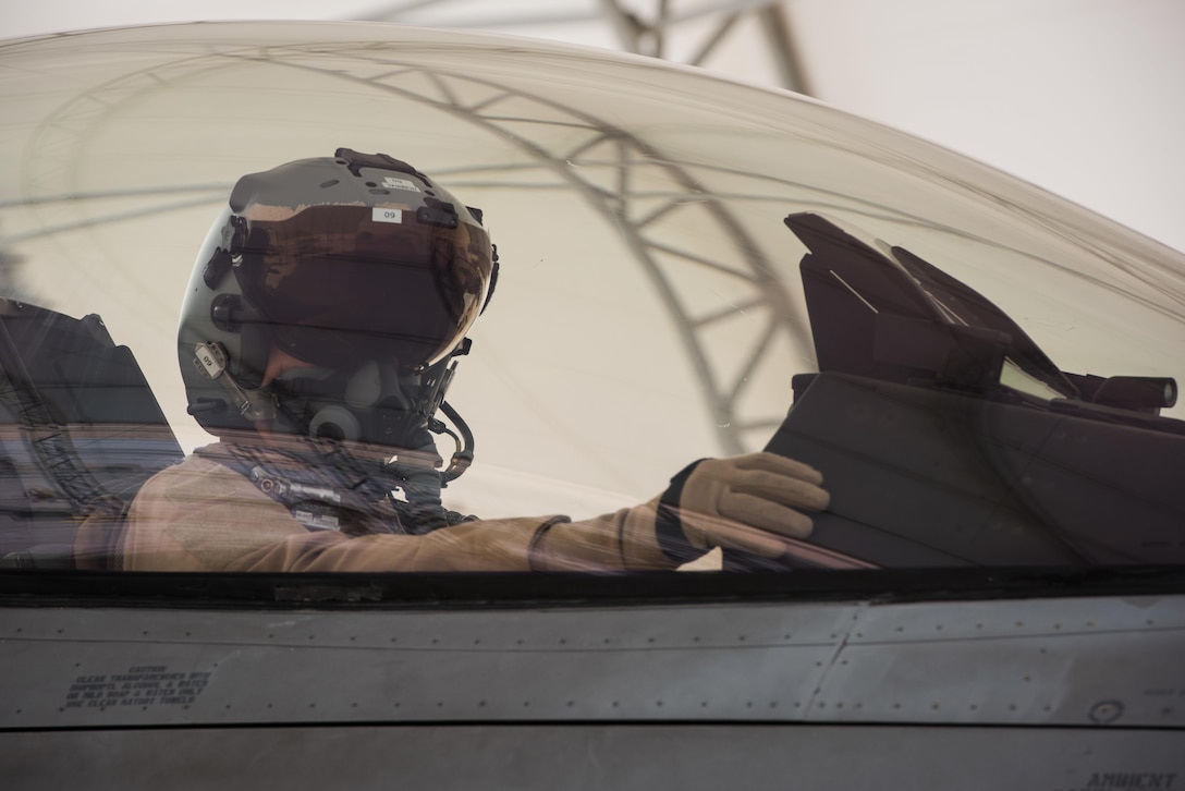 A Polish air force pilot performs preflight checks in an F-16 Fighting Falcon before taxiing for a mission at the 407th Air Expeditionary Group in Southwest Asia, April 24, 2017. The Polish airmen are part of the 60-nation coalition force supporting Operation Inherent Resolve in the fight against the Islamic State of Iraq and Syria. Air Force photo by Master Sgt. Benjamin Wilson