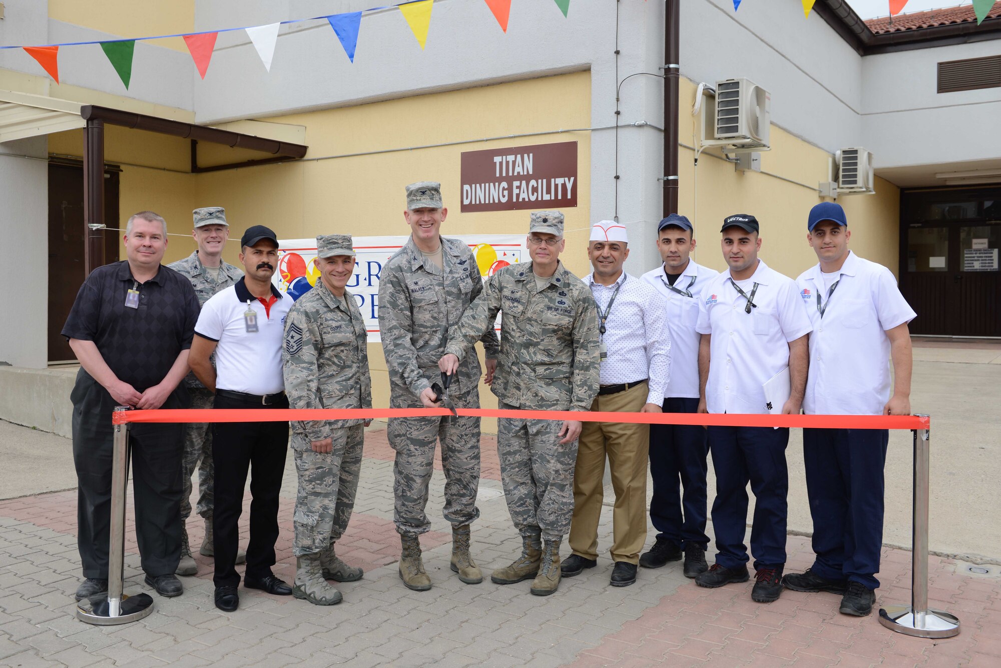 Members of the 39th Air Base Wing cut the ribbon at the grand opening of the Titan Dining Facility May 1, 2017, at Incirlik Air Base, Turkey. The grand opening marked the fourth dining facility on base. (U.S. Air Force photo by Airman 1st Class Devin M. Rumbaugh)