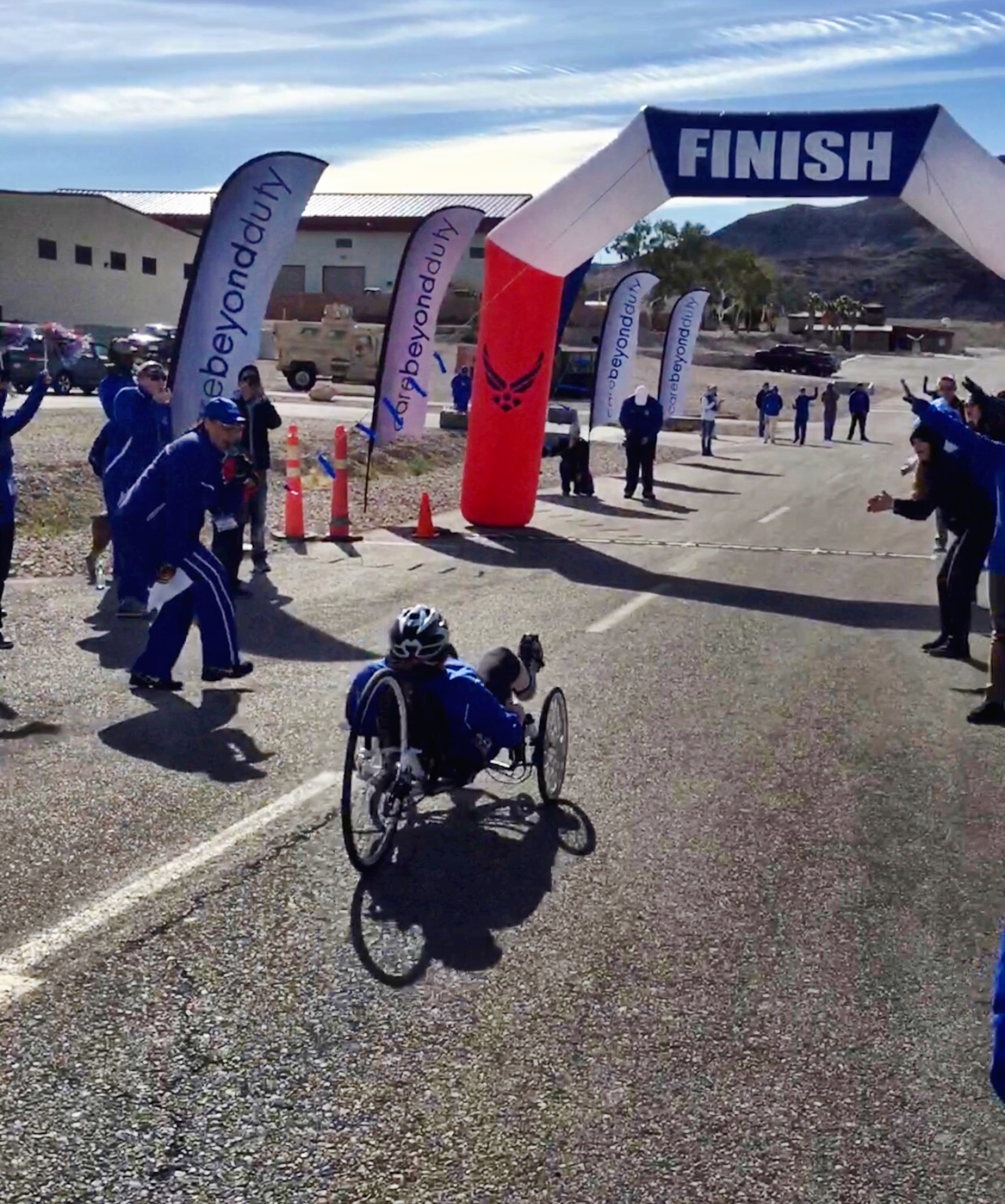 Lt. Col. Jackie Burns, 552nd Air control Group, 552nd Air Control Wing, prepares to cross the finish line on her way to earning a Silver Medal in Cycling on a recumbent bike , at the Wounded Warrior Trials held Feb. 17, at Nellis Air Force Base, Nev.  Burns was selected to the primary Air Force team which will compete at the Warrior Games June 30- July 8 in Chicago.  (Air Force photo by Marty Burns)