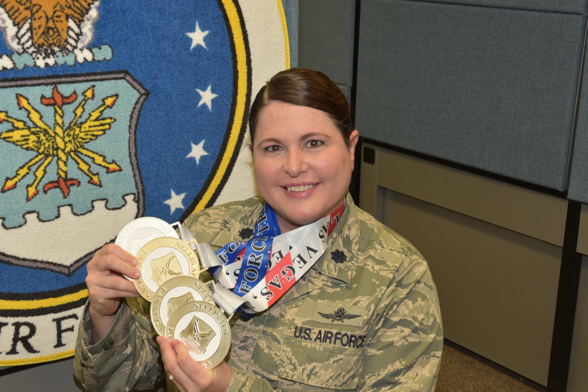 Lt. Col. Jackie Burns, 552nd Air control Group, 552nd Air Control Wing, displays the medals she earned at the Wounded Warrior Trials at Nellis Air force Base, Nev. Feb. 17. Burns had Silvers in 5K Cycling, 100-meter Free Style, Discus and a Bronze Medal in the 50-meter BackStroke.  Burns was selected as a primary Wounded Warrior team member and will compete in the Warrior Games June 30-July 8 in Chicago.  (Air Force photo by Ron Mullan)