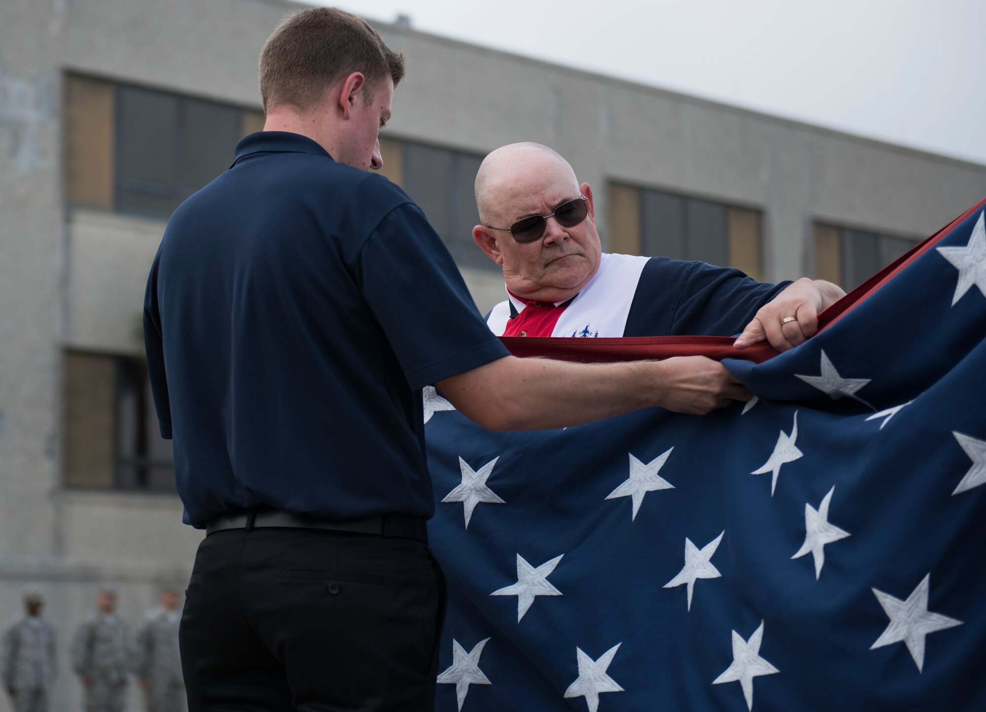 Team Eglin civilians fold the flag during the all-civilian retreat ceremony April 27 at Eglin Air Force Base, Fla. The all-civilian retreat was held to show support for our military members. (U.S. Air Force photo/Ilka Cole)