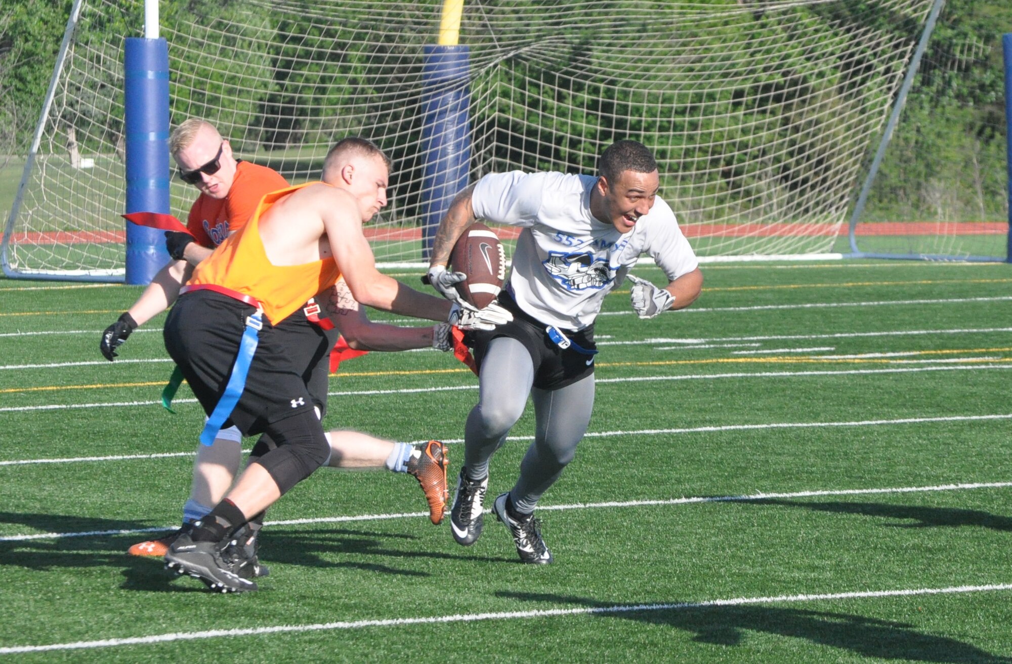 552nd AMXS player Michael is raring to run April 18 after he caught a short pass from quarterback Marc. AMXS defeated 552nd MXS 14-0 in intramural football. AMXS’ record bumped up to 4-1 with the win, placing it one game behind undefeated Reserve Gold as of that date. (Air Force photo by John Parker)