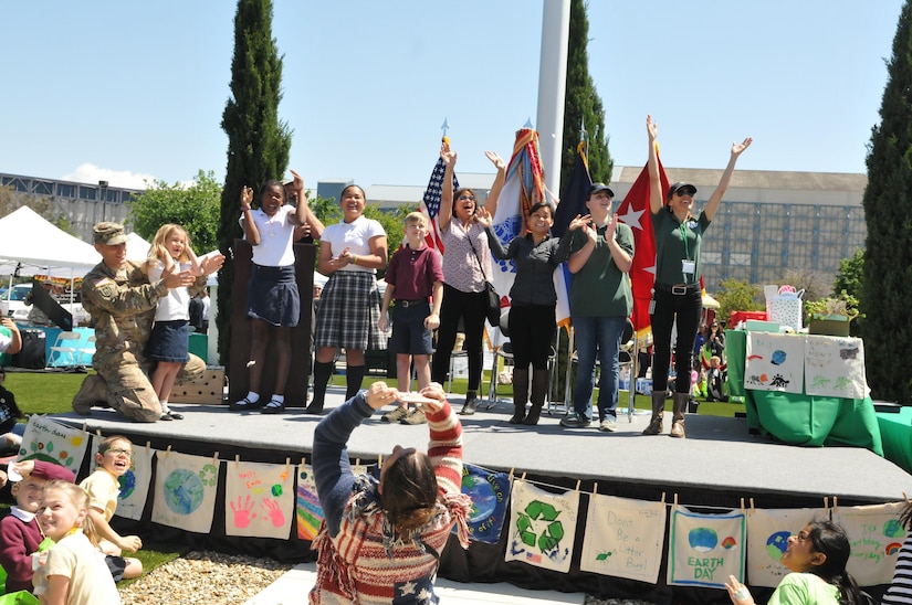 Participants on the stage excitedly released pigeons during the 63d Regional Support Command Earth Day event held at the Sergeant James Witkowski Armed Forces Reserve Center in Mountain View.
