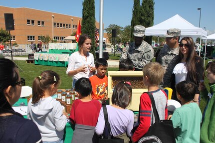 The 63d Regional Support Command Soldiers and students learn about the process of making honey and importance of bees from Kendal’s Bees during the Earth Day event held at the Sergeant James Witkowski Armed Forces Reserve Center in Mountain View.