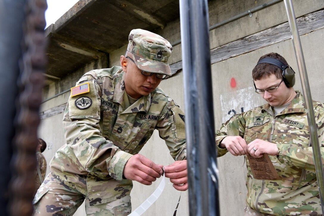 Sgt. 1st Class Shawn Arriola, training chief at Ft. McCoy NCO Academy, prepares the target for the next firing round while Sgt. Stephen Hale, a military police with the 415th MP Detachment, prepares for a lunch break.  Soldiers representing 20 U.S. Army Reserve units from all over the country competed in the 2017 U.S. Army Reserve Midwestern Small Arms Championship at Camp Atterbury, Indiana April 21-24.