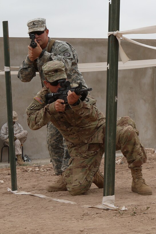 Sgt. Derek Ball and Spc. Antonio Bowden military policemen representing the 805th MP Company from Cary N.C., complete L-shaped hall clearing during Exercise African Lion 17 April 24, at Tifnit, Morocco. African Lion conducts a joint, multilateral exercise that promotes interoperability and mutual understanding of countries’ tactics, techniques, and procedures while reinforcing the bonds forged between their militaries.