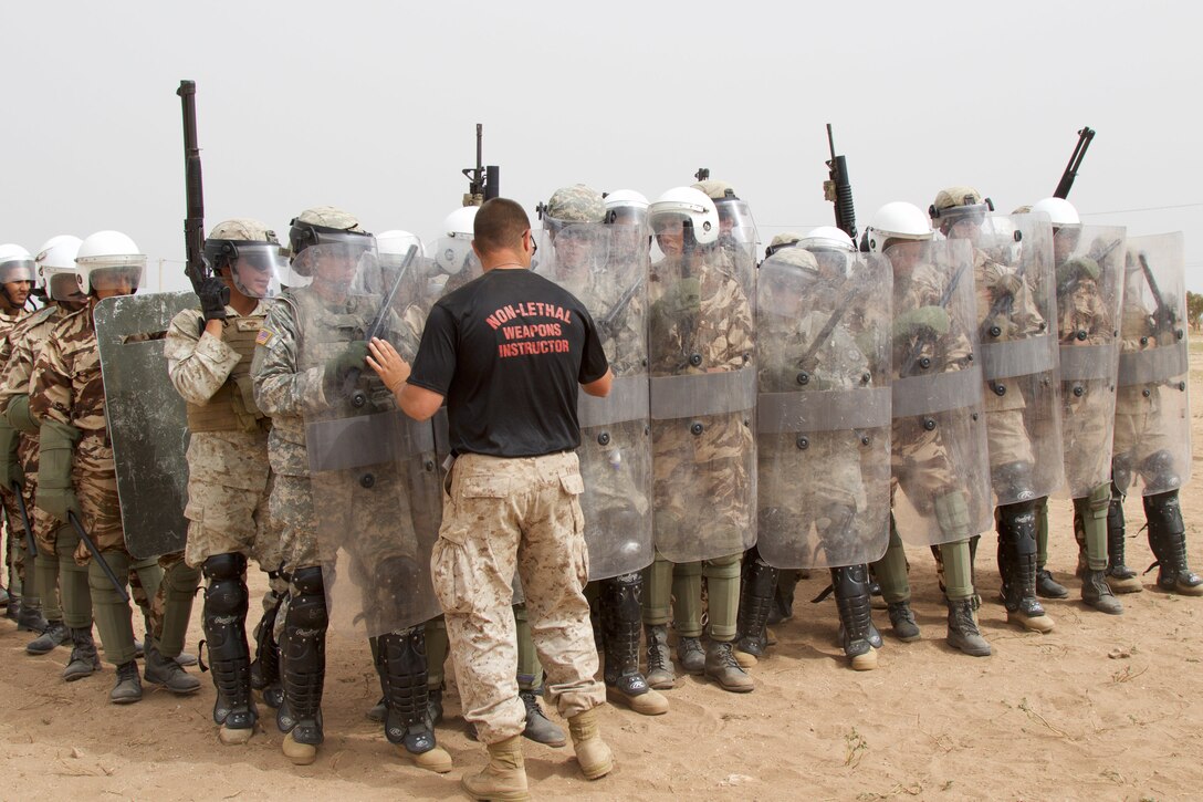 Sgt. Brian Fayman, a non-lethal weapons instructor with Reserve Military Police Company Bravo from Pittsburgh P.A., provides guidance to U.S. Soldiers representing the 805th Military Police Company from Cary N.C and Marines with Alpha 3rd Marine Fleet Antiterrorism Security Team as they participate in crowd control training with Royal Moroccan Armed Forces during Exercise African Lion 17 April 23, at Tifnit, Morocco. Exercise African Lion is an annually scheduled, combined multilateral exercise designed to improve interoperability and mutual understanding of each nation’s tactics, techniques and procedures.