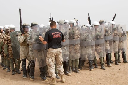 Sgt. Brian Fayman, a non-lethal weapons instructor with Reserve Military Police Company Bravo from Pittsburgh P.A., provides guidance to U.S. Soldiers representing the 805th Military Police Company from Cary N.C and Marines with Alpha 3rd Marine Fleet Antiterrorism Security Team as they participate in crowd control training with Royal Moroccan Armed Forces during Exercise African Lion 17 April 23, at Tifnit, Morocco. Exercise African Lion is an annually scheduled, combined multilateral exercise designed to improve interoperability and mutual understanding of each nation’s tactics, techniques and procedures.