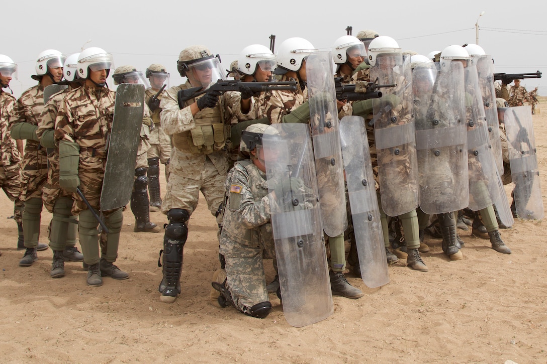 U.S. Soldiers representing the 805th Military Police Company from Cary N.C and Marines with Alpha 3rd Marine Fleet Antiterrorism Security Team participate in crowd control training with Royal Moroccan Armed Forces during Exercise African Lion 17 April 23, at Tifnit, Morocco.  Exercise African Lion is an annually scheduled, combined multilateral exercise designed to improve interoperability and mutual understanding of each nation’s tactics, techniques and procedures.