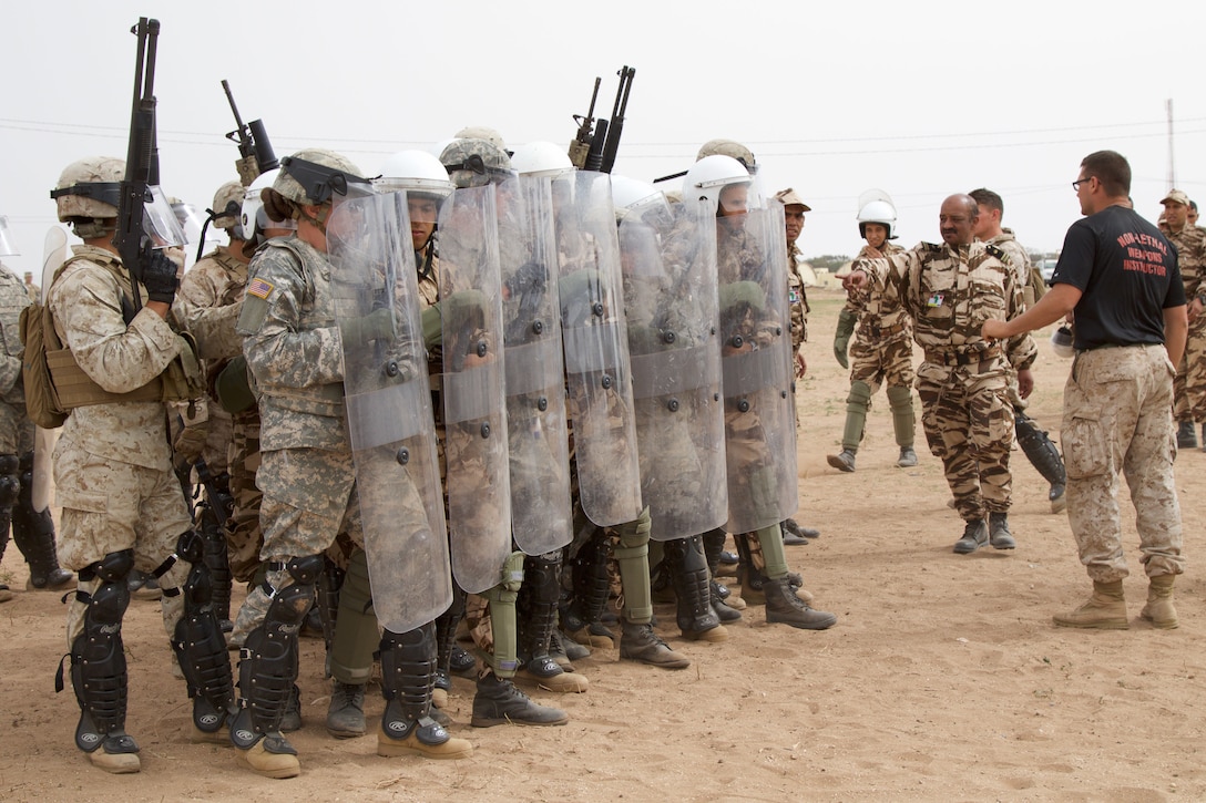 Sgt. Brian Fayman, a non-lethal weapons instructor with Reserve Military Police Company Bravo from Pittsburgh P.A., provides guidance to U.S. Soldiers representing the 805th Military Police Company from Cary N.C and Marines with Alpha 3rd Marine Fleet Antiterrorism Security Team as they participate in crowd control training with Royal Moroccan Armed Forces during Exercise African Lion 17 April 23, at Tifnit, Morocco. Exercise African Lion is an annually scheduled, combined multilateral exercise designed to improve interoperability and mutual understanding of each nation’s tactics, techniques and procedures.
