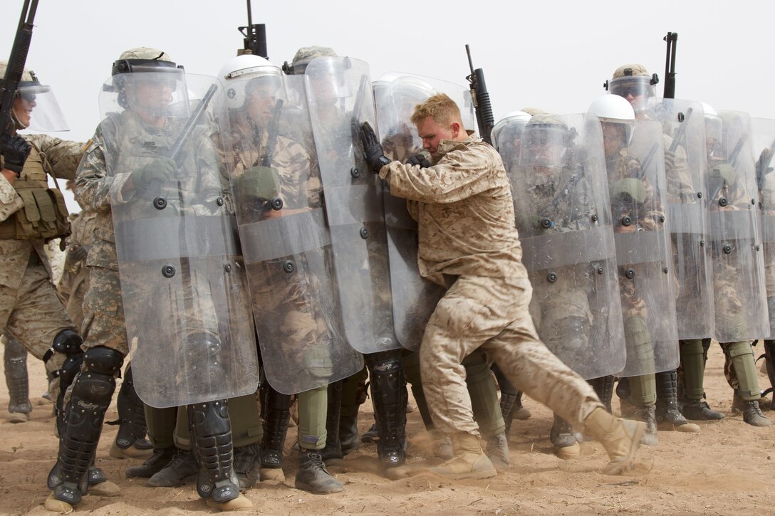 U.S. Marine with Alpha 3rd Marine Fleet Antiterrorism Security Team (FAST) participates in crowd control training as an enemy combatant with U.S. Soldiers and Royal Moroccan Armed Forces during Exercise African Lion 17 April 23, at Tifnit, Morocco.Exercise African Lion is an annually scheduled, combined multilateral exercise designed to improve interoperability and mutual understanding of each nation’s tactics, techniques and procedures. 