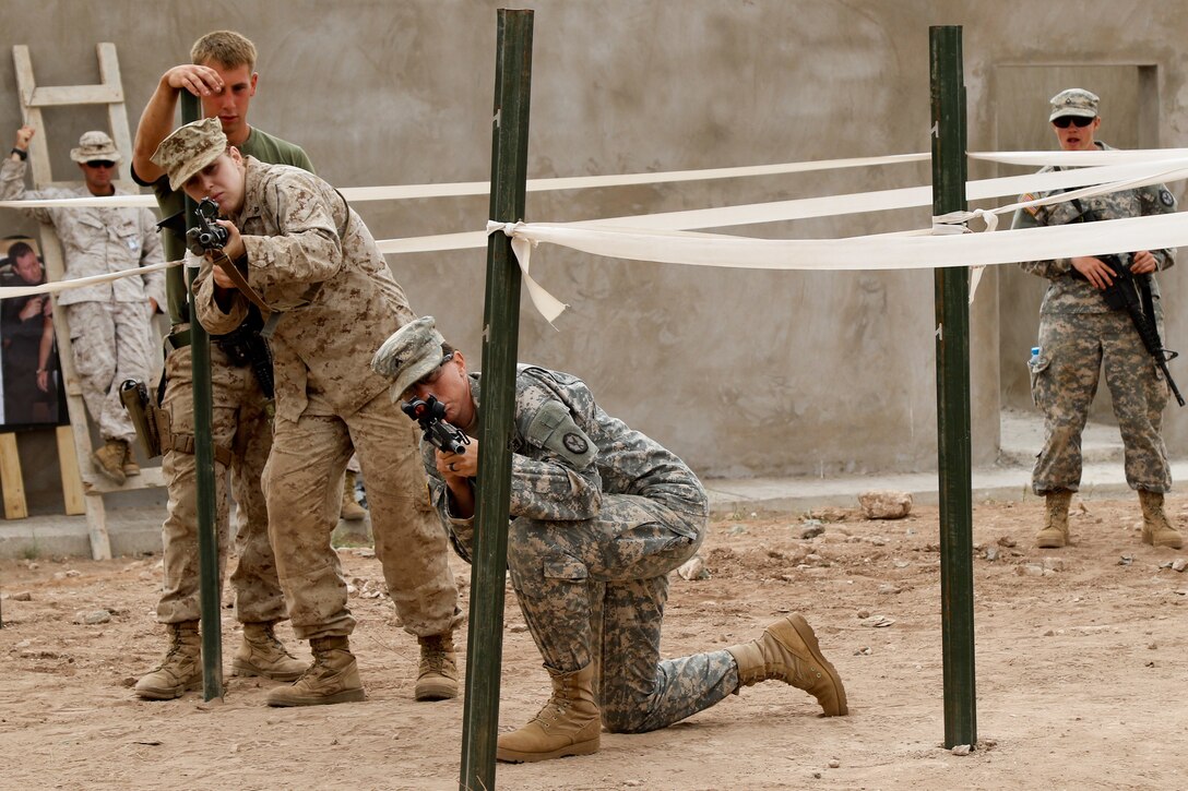 U.S. Soldier and Marine representing the 805th Military Police Company and the Alpha 3rd Marine Fleet Antiterrorism Security Team, complete L-shaped hall clearing training during Exercise African Lion 17 April 24, at Tifnit, Morocco. Exercise African Lion is annually scheduled, combined multilateral exercise designed to improve interoperability and mutual understanding of each nation’s tactics, techniques and procedures. 