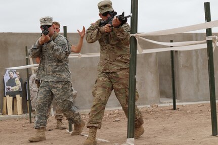 Sgt. Derek Ball and Spc. Antonio Bowden, military policemen representing the 805th MP Company from Cary N.C.; complete L-shaped hall clearing during Exercise African Lion 17 April 24, at Tifnit, Morocco. By training together the U.S. military and Moroccan Army will further develop tactics, techniques, and procedures that enhance interoperability between the two countries.