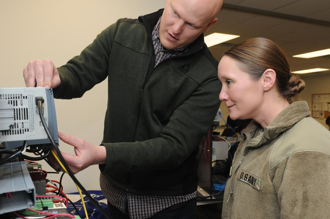 Maj. Christine Pierce, the Pennsylvania National Guard Defensive Cyber Operations Elements team chief, and Scott Poley, security operations center supervisor at FirstEnergy, complete the practical exercise that concludes the ISA CS34/CS37 62443 Cybersecurity Design Specialist/Maintenance Specialist course as part of Cyber Shield 17 at Camp Williams, Utah, April 28, 2017. Cyber Shield 17 is the sixth iteration of this training exercise and this year unites the Army National Guard with members of the Air National Guard, Army Reserve, and civilians from private companies, state government agencies, federal agencies, industry partners, and academia. (U.S. Army National Guard photo by Sgt. Michael Giles)