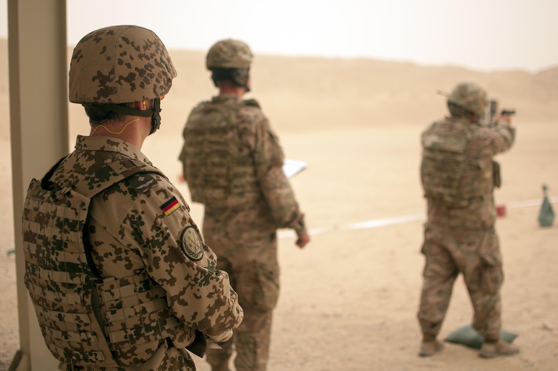 A German officer supervises as U.S. Army Central Command Soldiers fire the M9 pistol during the marksmanship portion of the German Armed Forces Badge qualification. The German Armed Forces Badge for Military Proficiency is one of the most sought after foreign awards in the United States Army. The 316th Sustainment Command (Expeditionary) and the 1st Sustainment Command (Theater) had the privilage of hosting the award qualifications at Camp Arifjan, Kuwait April 27, 2017.