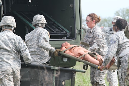 Army Reserve Spc. Ryan Flores and Spc. Bailey Jungmann of the 469th Medical Company, Wichita, Kansas team up with Air Force Staff Sgt. Cherrelle Warren and Airman 1st Class Echo Heldreth of the 779th Medical Group, Macdill Air Force Base, Tampa, Florida to load a mannequin patient into a M997 4 litter HMMWV at Responders Support Camp (RSC) Nighthawk, Indiana during Guardian Response 17 on April 29, 2017. 

Nearly 5,000 Soldiers and Airmen from across the country are participating in Guardian Response 17, a multi-component training exercise to validate the military's ability to support Civil Authorities in the event of a Chemical, Biological, Radiological, and Nuclear (CBRN) catastrophe. (U.S. Army Reserve photo by Staff Sgt. Christopher Sofia/Released)