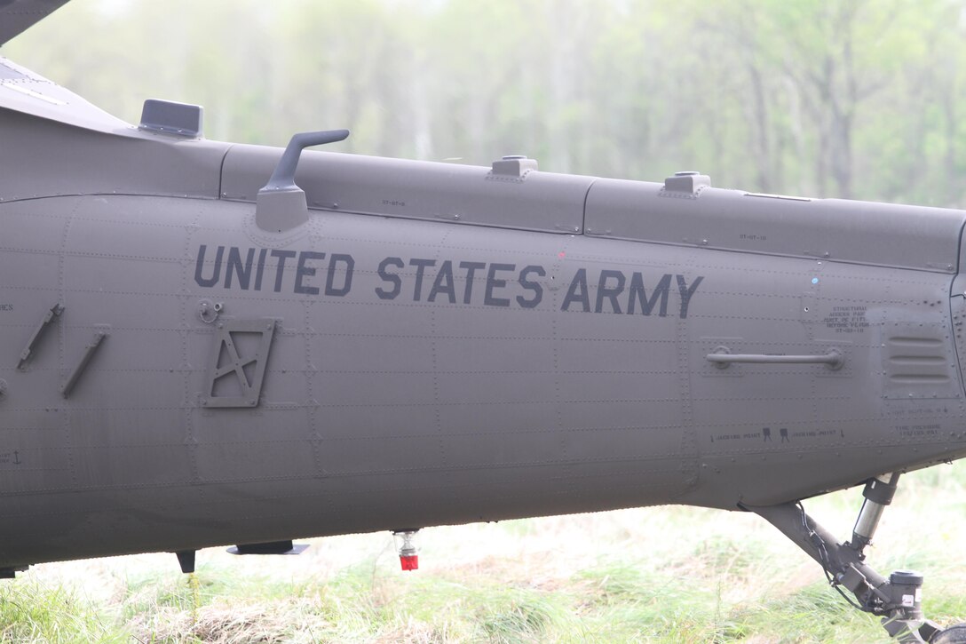 The tail end of a UH-60 Black Hawk helicopter paused at the landing zone while crews unload mannequin patients at Responders Support Camp Night Hawk, Camp Atterbury, Indiana during Guardian Response 17 on April 29, 2017. 

Nearly 5,000 Soldiers and Airmen from across the country are participating in Guardian Response 17, a multi-component training exercise to validate the military's ability to support Civil Authorities in the event of a Chemical, Biological, Radiological, and Nuclear (CBRN) catastrophe. (U.S. Army Reserve photo by Staff Sgt. Christopher Sofia/Released)