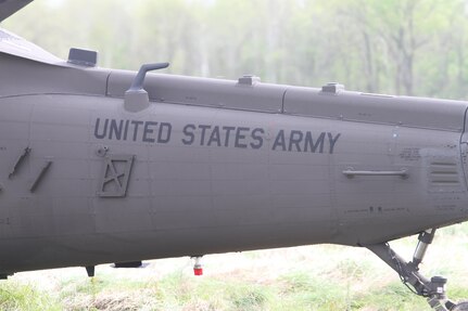 The tail end of a UH-60 Black Hawk helicopter paused at the landing zone while crews unload mannequin patients at Responders Support Camp Night Hawk, Camp Atterbury, Indiana during Guardian Response 17 on April 29, 2017. 

Nearly 5,000 Soldiers and Airmen from across the country are participating in Guardian Response 17, a multi-component training exercise to validate the military's ability to support Civil Authorities in the event of a Chemical, Biological, Radiological, and Nuclear (CBRN) catastrophe. (U.S. Army Reserve photo by Staff Sgt. Christopher Sofia/Released)