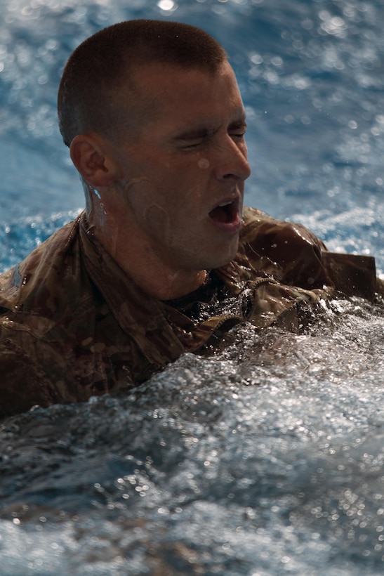 Spc. William Lloyd, a Cable Systems Installer-Maintainer with the 316th Sustainment Command (Expeditionary), de-robes after completing the swim portion of the German Armed Forces Badge qualification. The German Armed Forces Badge for Military Proficiency is one of the most sought after foreign awards in the United States Army. The 316th ESC and the 1st Sustainment Command (Theater) had the privilage of hosting the award qualifications at Camp Arifjan, Kuwait April 27, 2017.