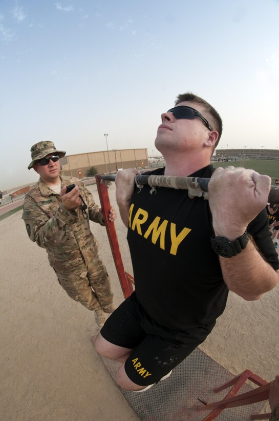 Spc. Justin Griffiths, a Cable Systems Installer-Maintainer with the 316th Sustainment Command (Expeditionary), participates in the flexed arm-hang during qualifications for the German Armed Forces Badge for Military Proficiency. The 316th ESC and the 1st Sustainment Command (Theater) had the privilage of hosting the award qualifications at Camp Arifjan, Kuwait April 27, 2017.