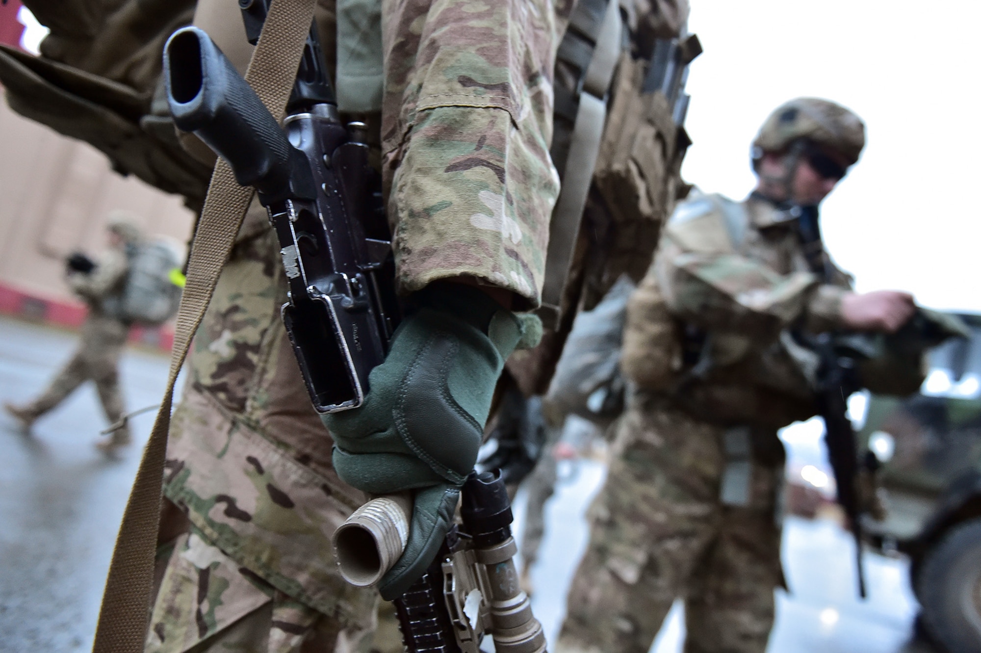 A soldier assigned to Comanche Company, 1st Battalion, 501st Parachute Infantry Regiment, 4th Infantry Brigade Combat Team (Airborne), 25th Infantry Division, U.S. Army Alaska, holds his M4 carbine as he waits for the order to begin a 12-mile tactical foot march on Joint Base Elmendorf-Richardson, Alaska, April 27, 2017. Foot marches are the movement of troops and equipment, mainly by foot, with limited support by vehicles. They are characterized by combat readiness, ease of control, adaptability to terrain, slow rate of movement, and increased personnel fatigue.