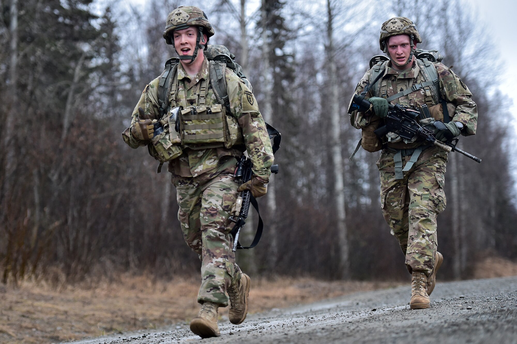 Spc. Justin Harvey, left, and Army Sgt. Mitchell Powell, both assigned to Comanche Company, 1st Battalion, 501st Parachute Infantry Regiment, 4th Infantry Brigade Combat Team (Airborne), 25th Infantry Division, U.S. Army Alaska, execute a 12-mile tactical foot march on Joint Base Elmendorf-Richardson, Alaska, April 27, 2017. Foot marches are the movement of troops and equipment, mainly by foot, with limited support by vehicles. They are characterized by combat readiness, ease of control, adaptability to terrain, slow rate of movement, and increased personnel fatigue.