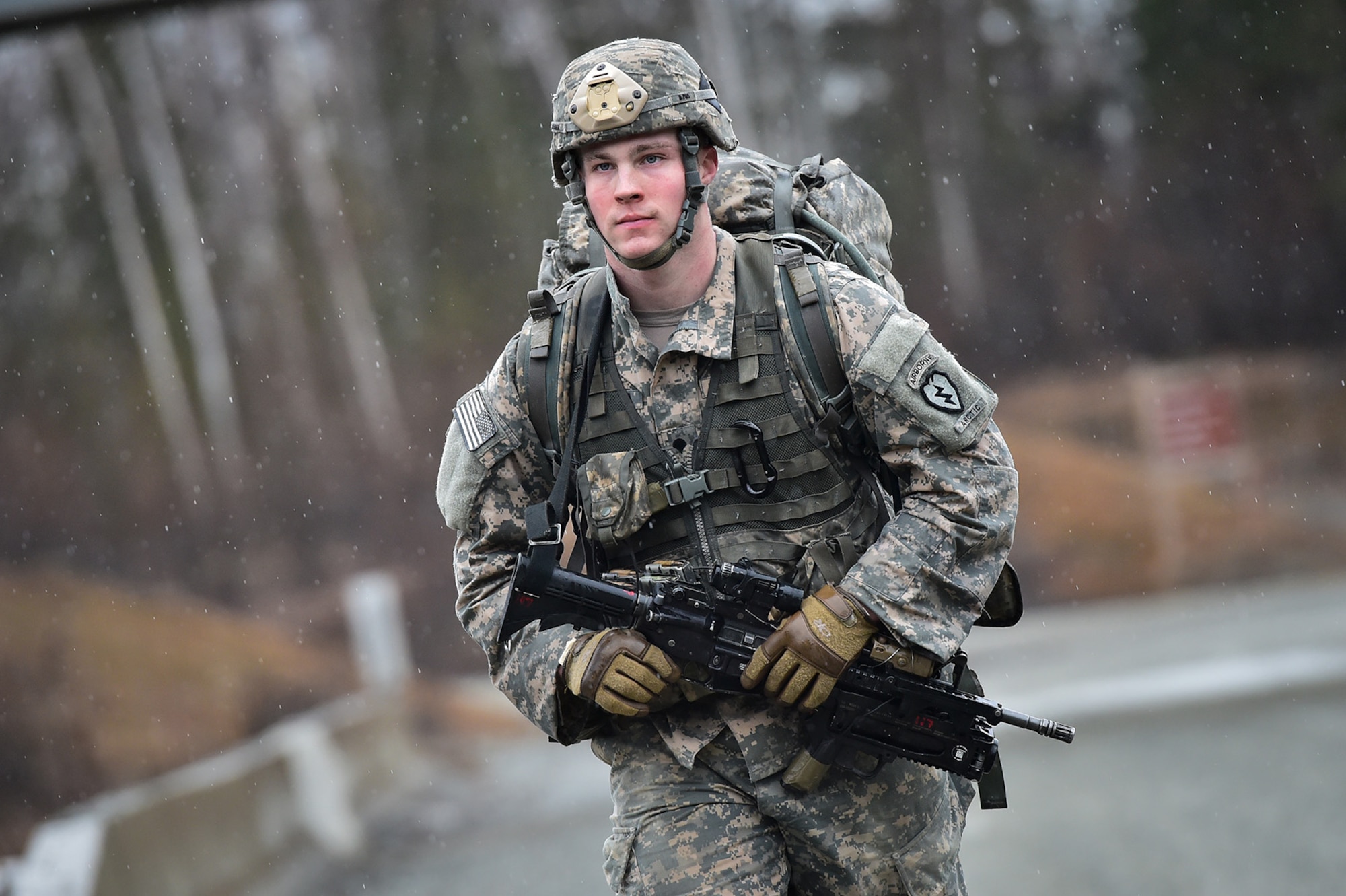 A soldier assigned to Comanche Company, 1st Battalion, 501st Parachute Infantry Regiment, 4th Infantry Brigade Combat Team (Airborne), 25th Infantry Division, U.S. Army Alaska, executes a 12-mile tactical foot march on Joint Base Elmendorf-Richardson, Alaska, April 27, 2017. Foot marches are the movement of troops and equipment, mainly by foot, with limited support by vehicles. They are characterized by combat readiness, ease of control, adaptability to terrain, slow rate of movement, and increased personnel fatigue.