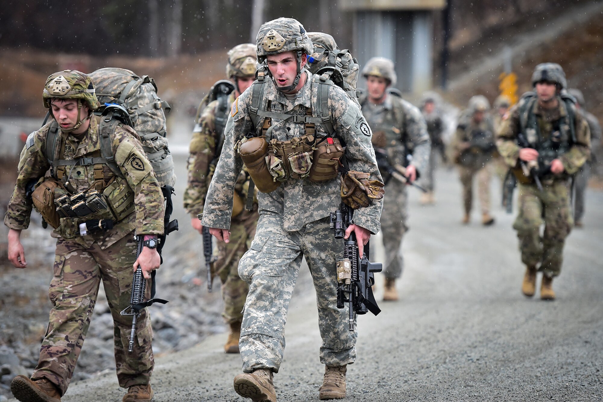 Spc. Joshua Talty, center, assigned to Comanche Company, 1st Battalion, 501st Parachute Infantry Regiment, 4th Infantry Brigade Combat Team (Airborne), 25th Infantry Division, U.S. Army Alaska, executes a 12-mile tactical foot march with fellow paratroopers on Joint Base Elmendorf-Richardson, Alaska, April 27, 2017. Foot marches are the movement of troops and equipment, mainly by foot, with limited support by vehicles. They are characterized by combat readiness, ease of control, adaptability to terrain, slow rate of movement, and increased personnel fatigue.
