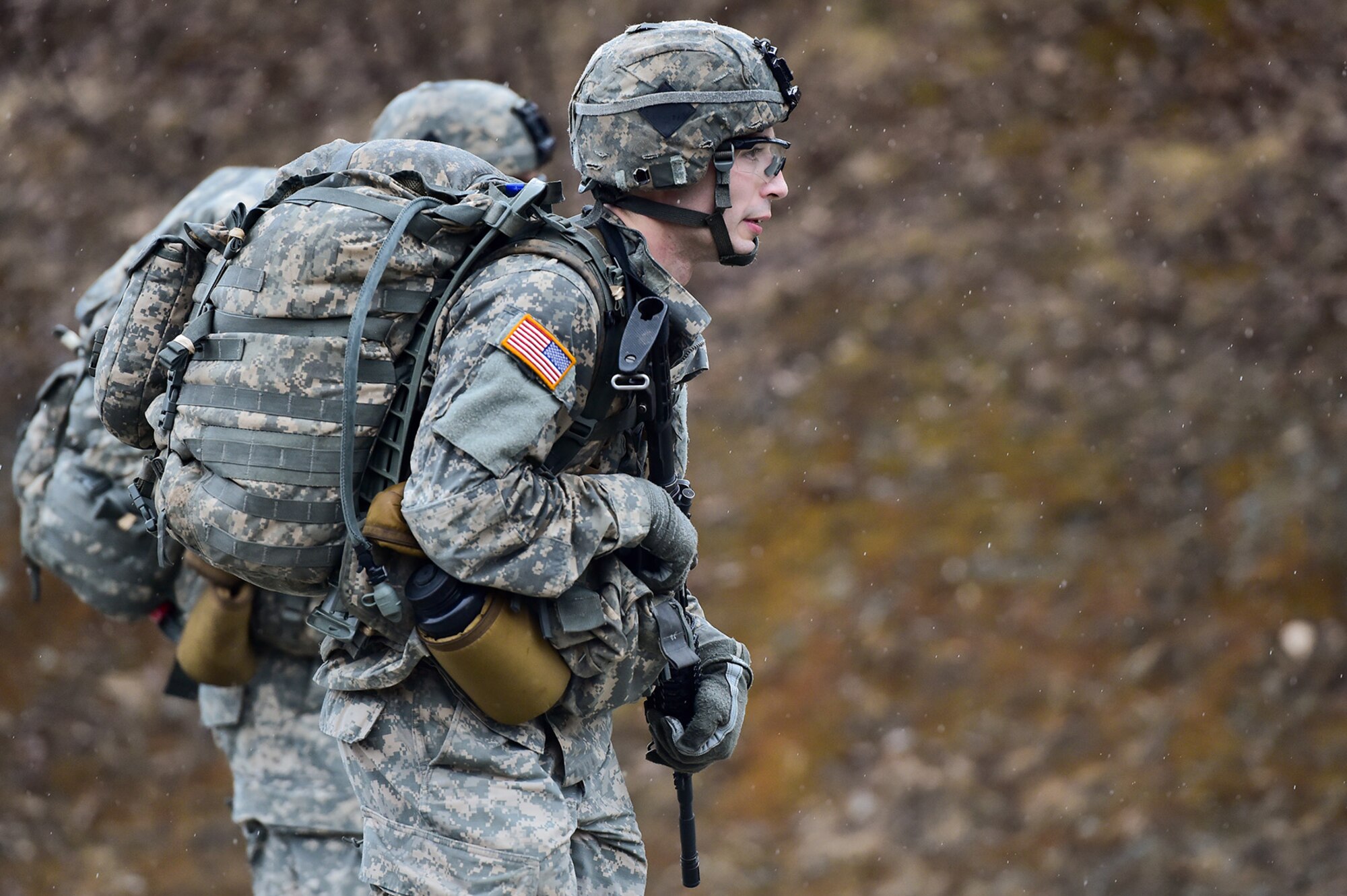 A soldier assigned to Comanche Company, 1st Battalion, 501st Parachute Infantry Regiment, 4th Infantry Brigade Combat Team (Airborne), 25th Infantry Division, U.S. Army Alaska, executes a 12-mile tactical foot march on Joint Base Elmendorf-Richardson, Alaska, April 27, 2017. Foot marches are the movement of troops and equipment, mainly by foot, with limited support by vehicles. They are characterized by combat readiness, ease of control, adaptability to terrain, slow rate of movement, and increased personnel fatigue.