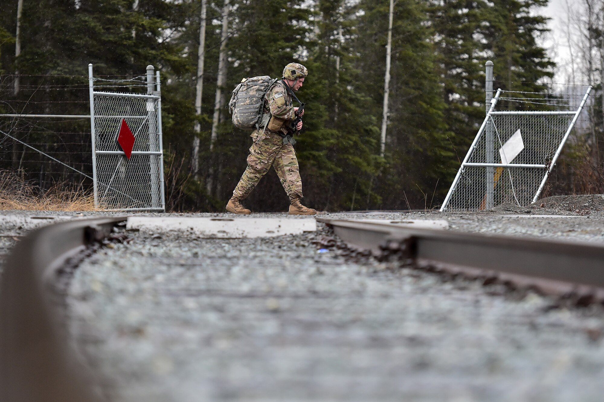 A soldier assigned to Comanche Company, 1st Battalion, 501st Parachute Infantry Regiment, 4th Infantry Brigade Combat Team (Airborne), 25th Infantry Division, U.S. Army Alaska, executes a 12-mile tactical foot march on Joint Base Elmendorf-Richardson, Alaska, April 27, 2017. Foot marches are the movement of troops and equipment, mainly by foot, with limited support by vehicles. They are characterized by combat readiness, ease of control, adaptability to terrain, slow rate of movement, and increased personnel fatigue.