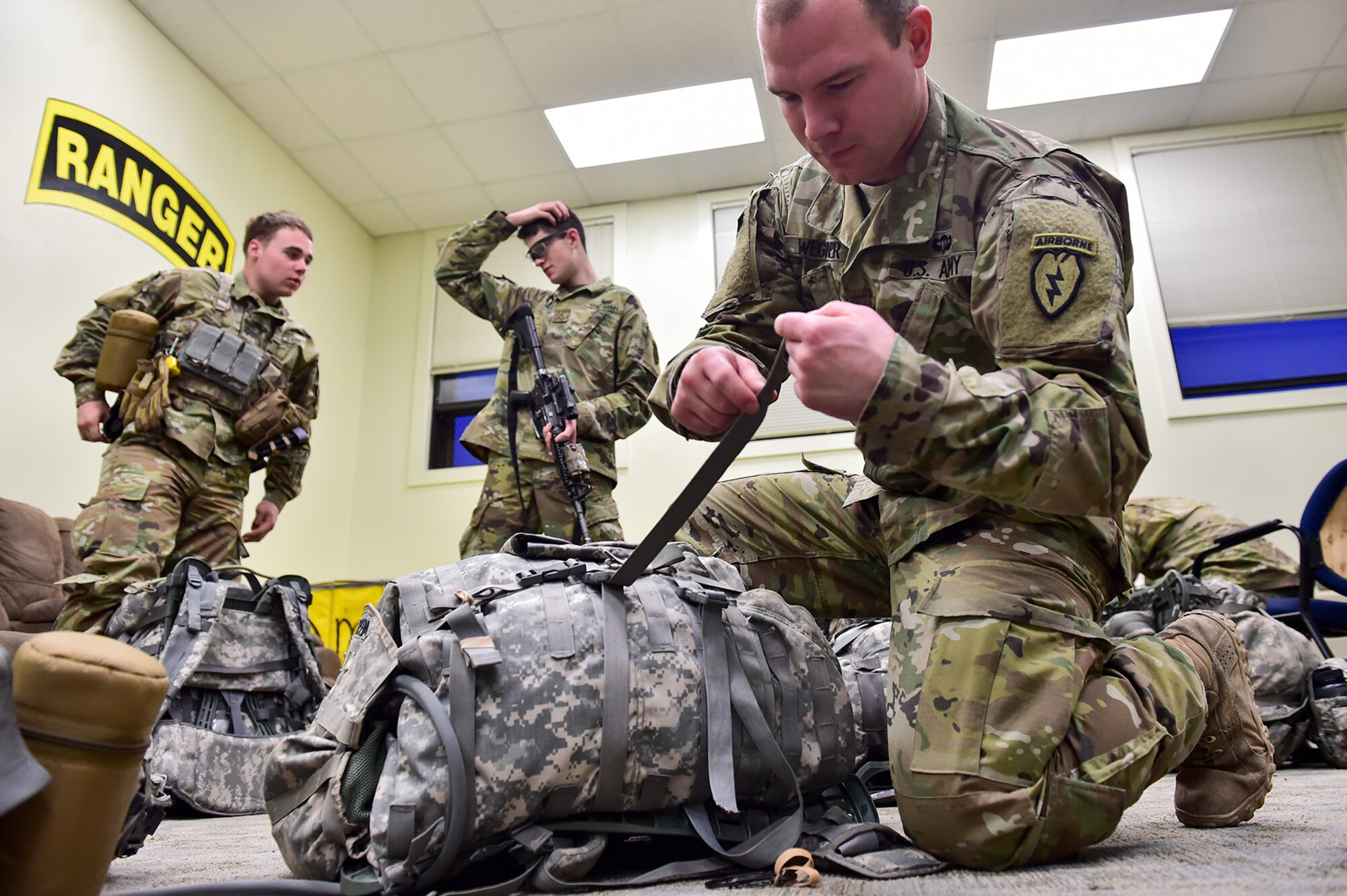 Army Spc. Nathan Wegner, a native of Waukesha, Wis., assigned to Comanche Company, 1st Battalion, 501st Parachute Infantry Regiment, 4th Infantry Brigade Combat Team (Airborne), 25th Infantry Division, U.S. Army Alaska, prepares his equipment for a 12-mile tactical foot march on Joint Base Elmendorf-Richardson, Alaska, April 27, 2017. Foot marches are the movement of troops and equipment, mainly by foot, with limited support by vehicles. They are characterized by combat readiness, ease of control, adaptability to terrain, slow rate of movement, and increased personnel fatigue.