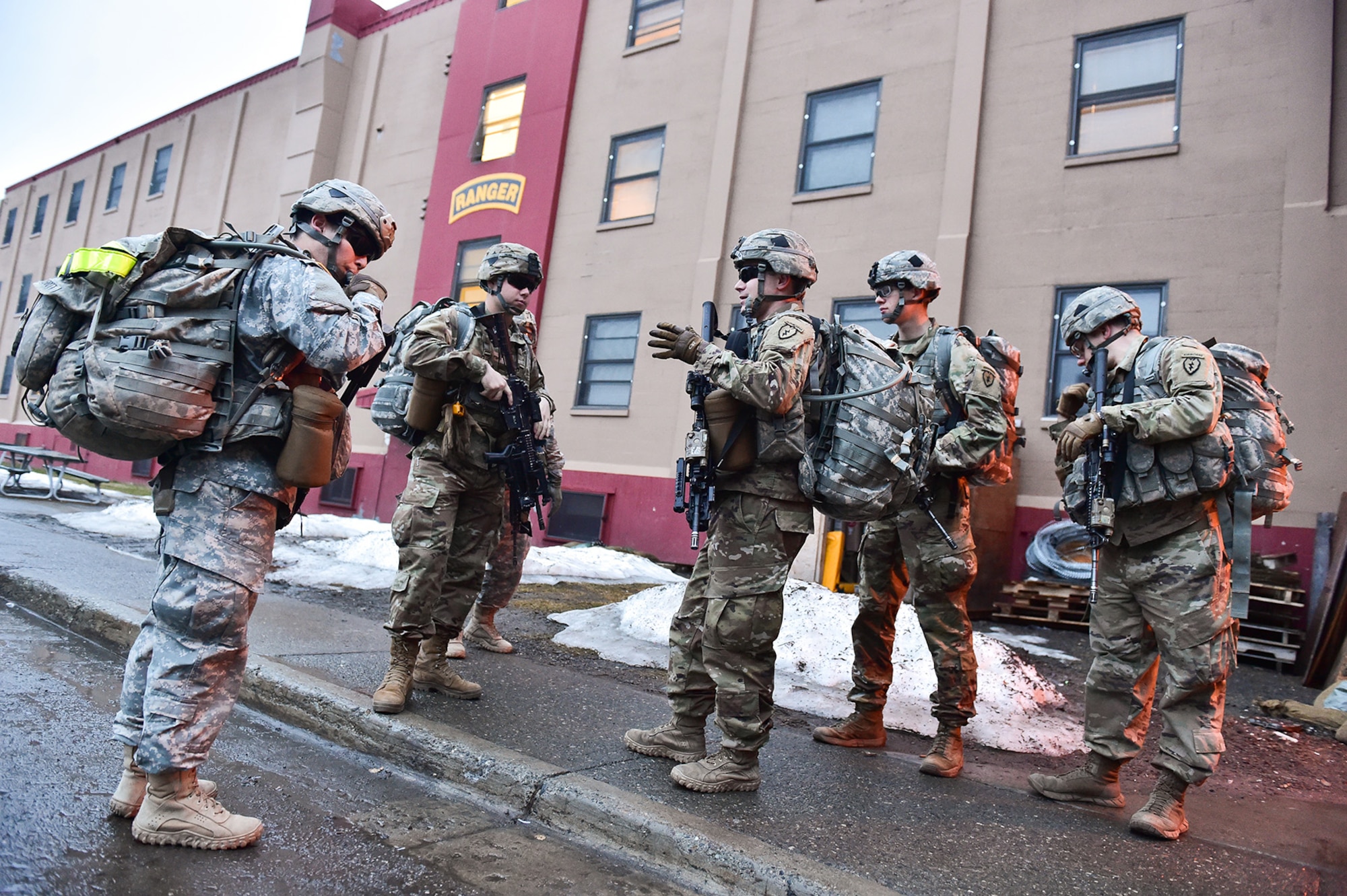 Soldiers assigned to Comanche Company, 1st Battalion, 501st Parachute Infantry Regiment, 4th Infantry Brigade Combat Team (Airborne), 25th Infantry Division, U.S. Army Alaska, wait for the order to begin a 12-mile tactical foot march on Joint Base Elmendorf-Richardson, Alaska, April 27, 2017. Foot marches are the movement of troops and equipment, mainly by foot, with limited support by vehicles. They are characterized by combat readiness, ease of control, adaptability to terrain, slow rate of movement, and increased personnel fatigue.