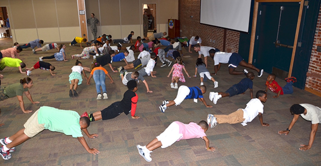 Children visiting Defense Supply Center Richmond, Virginia with their parents or grandparents April 27, 2017 participated in a military physical fitness activity as part of Take Our Daughters and Sons to Work Day. 