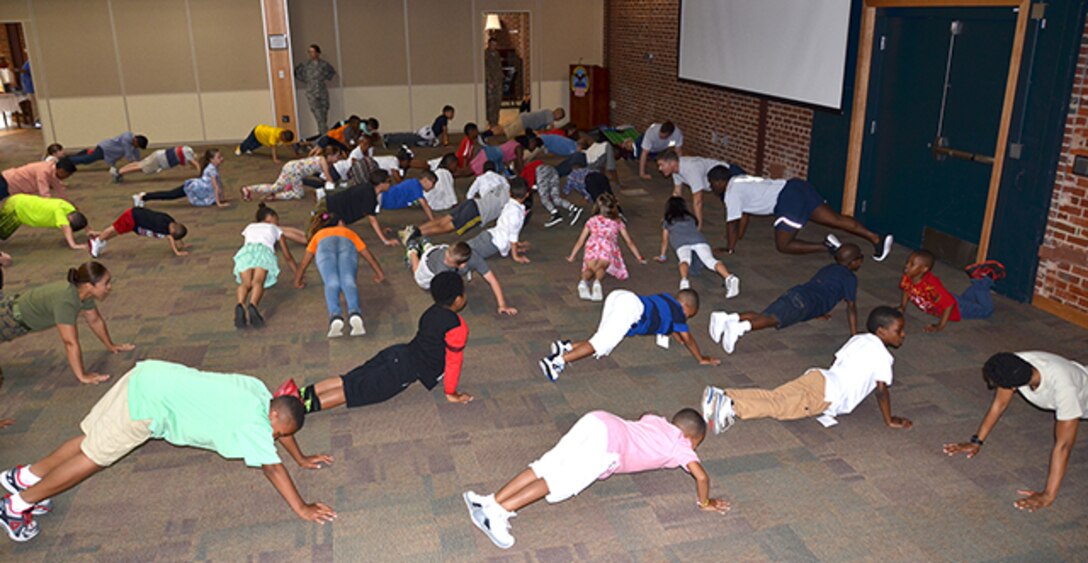 Children visiting Defense Supply Center Richmond, Virginia with their parents or grandparents April 27, 2017 participated in a military physical fitness activity as part of Take Our Daughters and Sons to Work Day. 