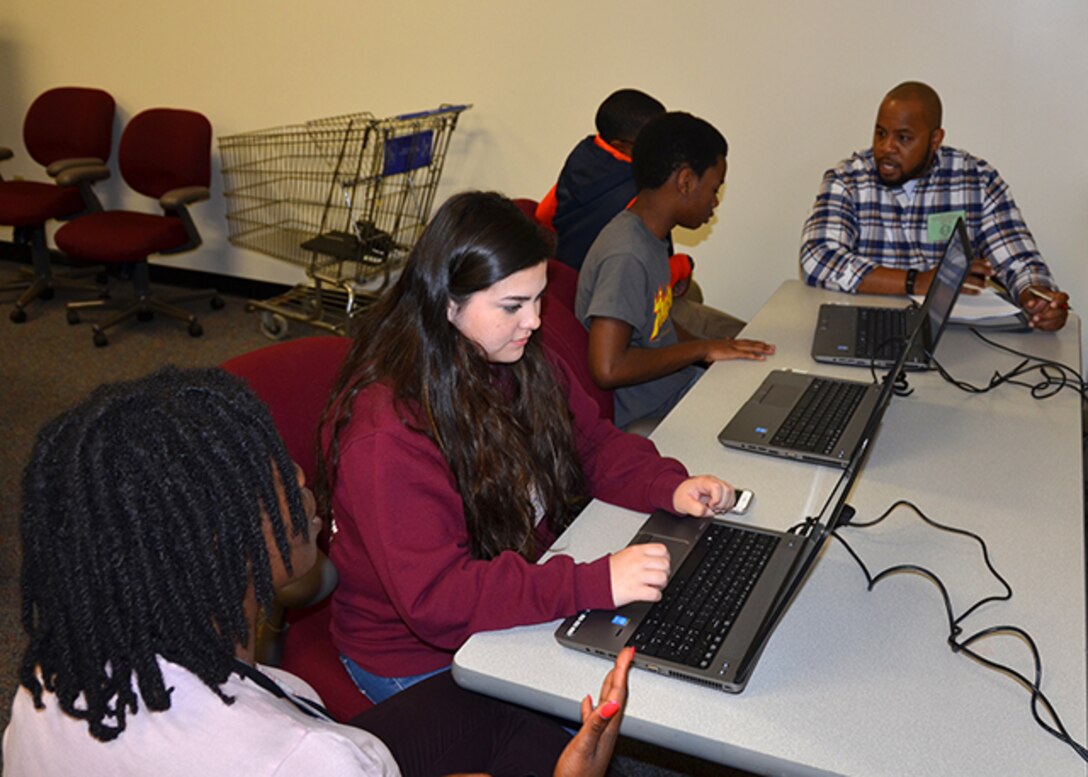 Albert Dorsey (plaid shirt), works with students to create personalized USAJobs resume accounts April 27,2017  as part of Defense Supply Center Richmond, Virginia’s Take Your Daughters and sons to Work Day.  Dorsey is a customer account specialist for DLA Aviation’s Air Force Customer Facing Division.