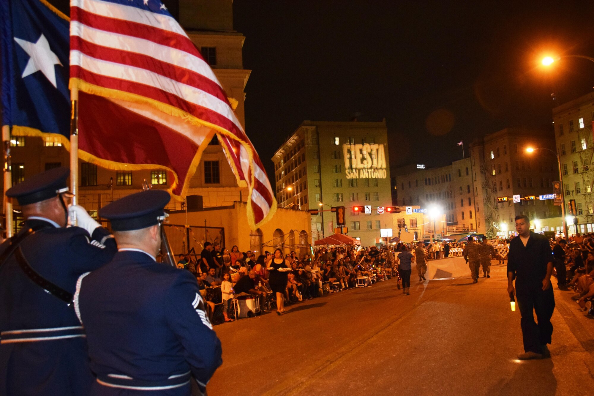 The 433rd Airlift Wing's Honor Guard marches down Broadway St. in downtown San Antonio during the 69th annual Fiesta Flambeau Parade, April 29, 2017. Over 700,000 spectators lined the 2.6 mile long route on the downtown streets of San Antonio to see over 200 floats and marching bands perform in the grand finale of Fiesta Week. (U.S. Air Force Photo/ Tech. Sgt. Carlos J. Trevino)