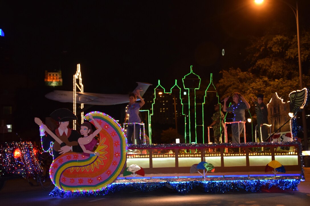 The 433rd Airlift Wing's “City Lights and Celebrations” themed float moves through downtown San Antonio during the 69th annual Fiesta Flambeau Parade, April 29, 2017. Over 700,000 spectators lined the 2.6 mile long route on the downtown streets of San Antonio to see over 200 floats and marching bands perform in the grand finale of Fiesta Week. (U.S. Air Force Photo/ Tech. Sgt. Carlos J. Trevino)