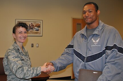 U.S. Air Force Col. Donna Turner, commander of the Air Force Services Activity, greets Capt. David Simon, after he was selected as an Air Force World Class Athlete Program bobsled pusher in August 2016. Simon is still aiming for a spot on the U.S. Bobsled Team that will compete in the 2018 Winter Olympics in Peyongchang, Republic of Korea. (U.S. Air Force photo by Carole Chiles Fuller)