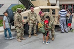 Soldiers from the Army 412th Civil Affairs Battalion (Airborne) display their vehicles and parachute equipment to visitors at Defense Supply Center's 'Take our daughters and sons to work day' event April 27. More than 100 children of DLA Land and Maritime and DFAS Columbus associates spent the day learning about the contributions their parents and guardians make to warfighter support.